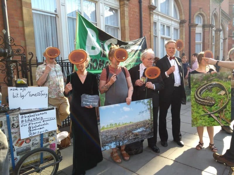 Masked forest flashmob targets world’s biggest biomass burners at conference in London